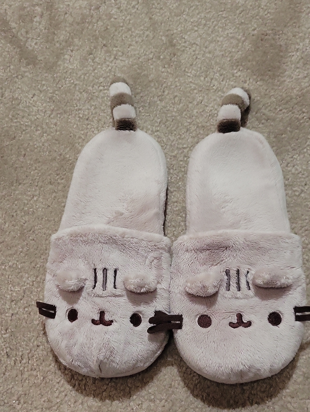 Pusheen Plush Slippers feature an adorable embroidered cat face, and Tail